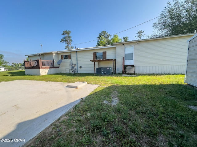 back of house featuring a lawn, a patio, a wooden deck, and entry steps