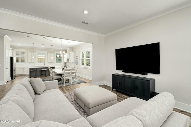 19 Mckenna Way, Santa Rosa Beach, FL 32459 - living room featuring crown molding, recessed lighting, light wood-style floors, and baseboards