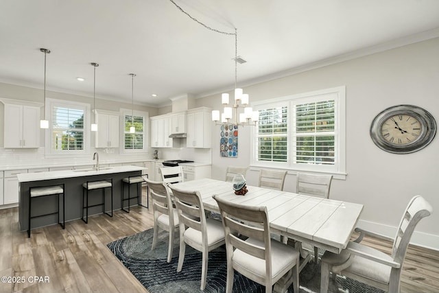 19 Mckenna Way, Santa Rosa Beach, FL 32459 - dining area with crown molding, recessed lighting, a notable chandelier, and wood finished floors