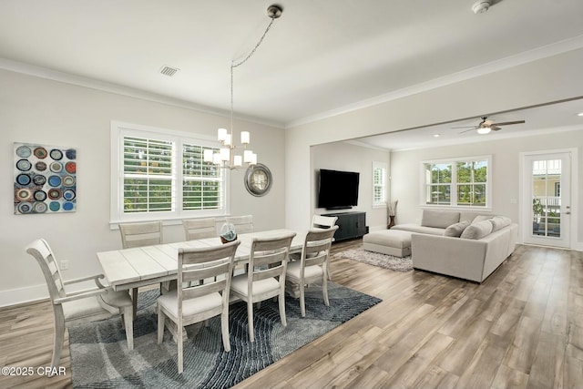 19 Mckenna Way, Santa Rosa Beach, FL 32459 - dining area with crown molding, light wood finished floors, baseboards, and ceiling fan with notable chandelier