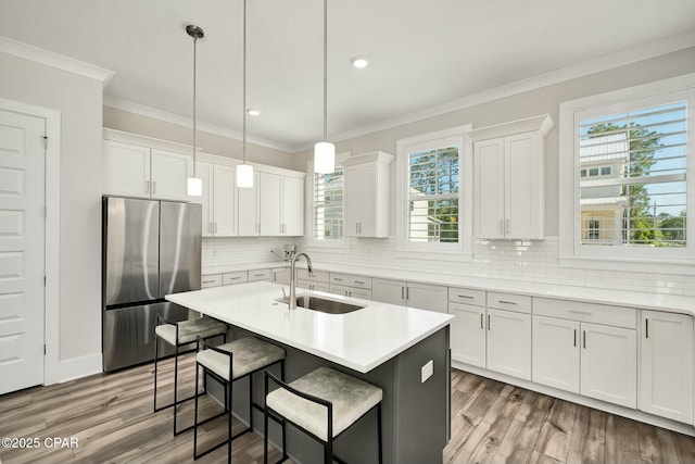 19 Mckenna Way, Santa Rosa Beach, FL 32459 - kitchen with stainless steel refrigerator, light wood-style floors, crown molding, and a sink
