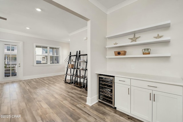 19 Mckenna Way, Santa Rosa Beach, FL 32459 - bar featuring a bar, light wood-style flooring, baseboards, ornamental molding, and beverage cooler