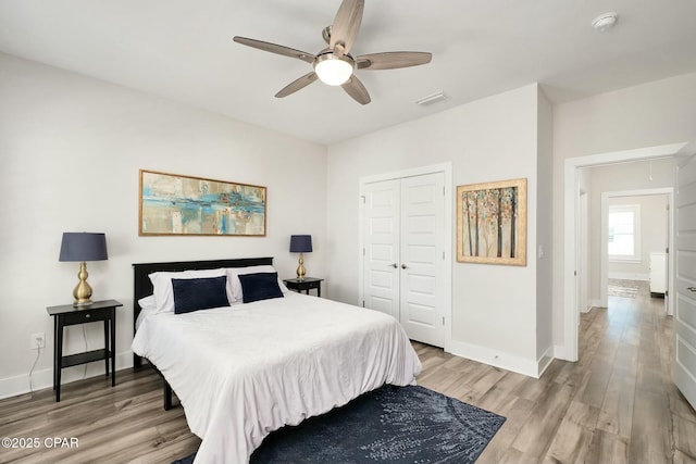 19 Mckenna Way, Santa Rosa Beach, FL 32459 - bedroom featuring visible vents, light wood-style floors, a closet, baseboards, and a ceiling fan