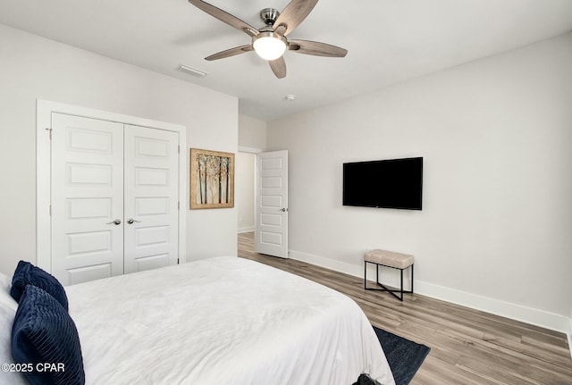 19 Mckenna Way, Santa Rosa Beach, FL 32459 - bedroom featuring wood finished floors, a closet, ceiling fan, baseboards, and visible vents