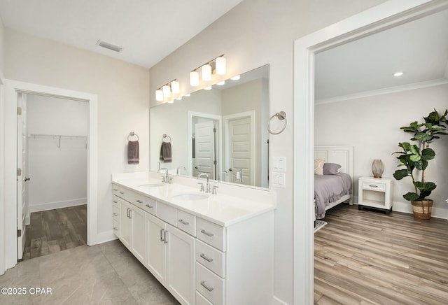 19 Mckenna Way, Santa Rosa Beach, FL 32459 - ensuite bathroom with visible vents, ornamental molding, double vanity, and a sink