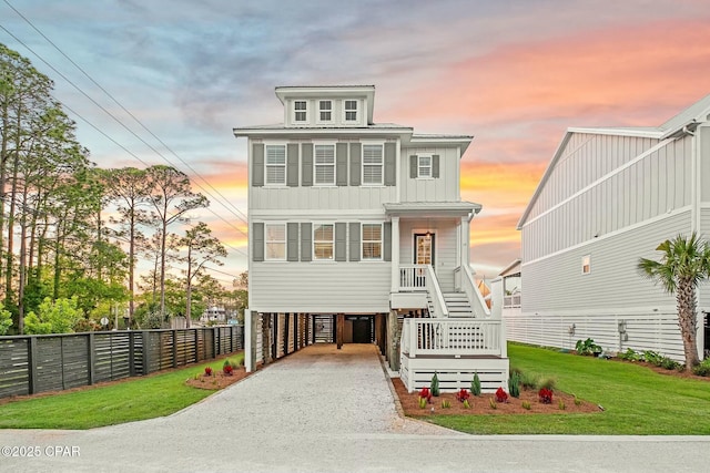 19 Mckenna Way, Santa Rosa Beach, FL 32459 - beach home with board and batten siding, gravel driveway, fence, a carport, and stairs