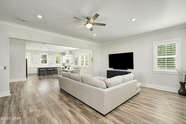 19 Mckenna Way, Santa Rosa Beach, FL 32459 - living room with baseboards, light wood-type flooring, ceiling fan, and crown molding