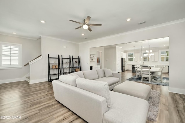 19 Mckenna Way, Santa Rosa Beach, FL 32459 - living room with light wood-style flooring, stairway, baseboards, ornamental molding, and a ceiling fan