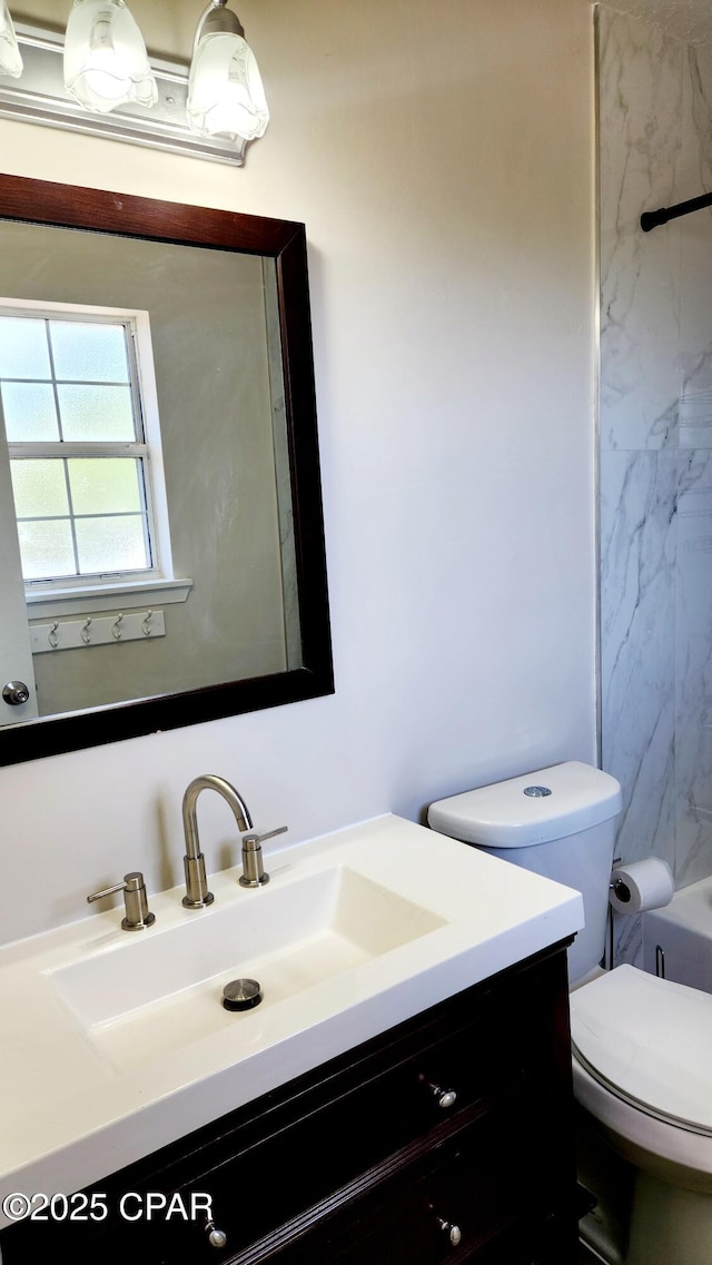 bathroom featuring toilet and vanity