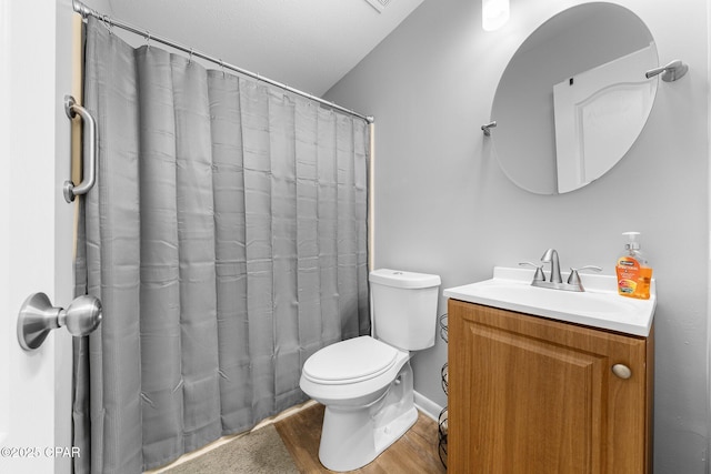 bathroom with a shower with shower curtain, toilet, wood finished floors, and vanity