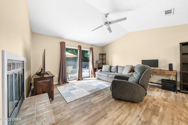 living room with visible vents, a ceiling fan, light wood finished floors, and lofted ceiling