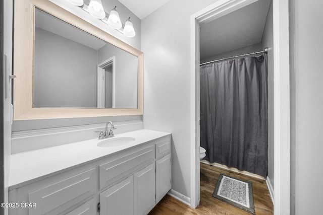full bath featuring vanity, toilet, curtained shower, wood finished floors, and visible vents
