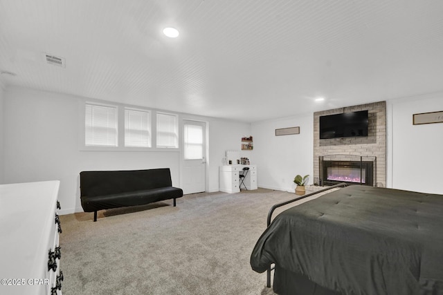 carpeted bedroom featuring recessed lighting, visible vents, baseboards, and a fireplace