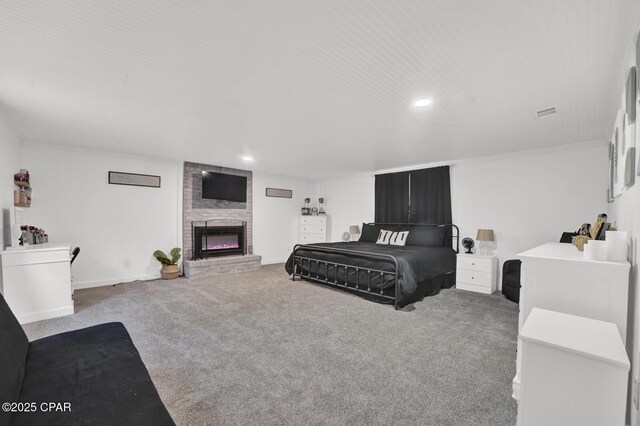 bedroom featuring a fireplace, visible vents, recessed lighting, and carpet floors