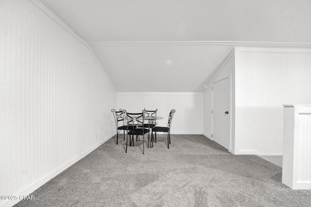 carpeted dining area featuring lofted ceiling