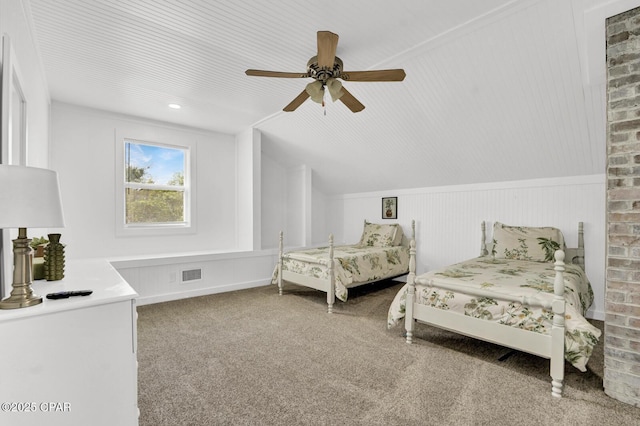 carpeted bedroom featuring lofted ceiling, visible vents, and a ceiling fan