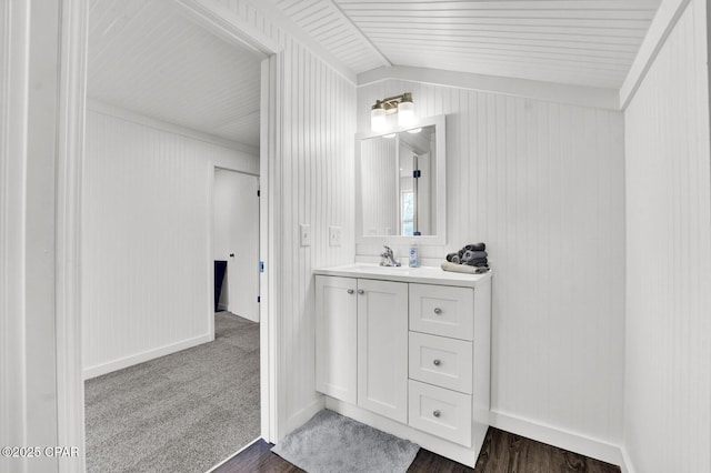 bathroom featuring baseboards, wood finished floors, and vanity