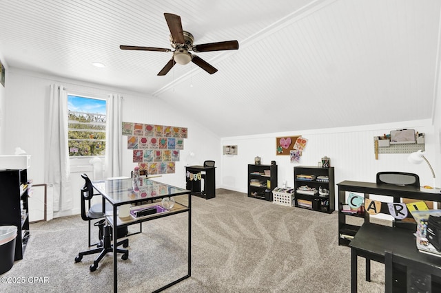 carpeted home office with ceiling fan and vaulted ceiling