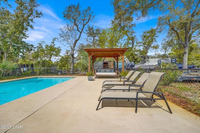 view of swimming pool with a patio, fence, a gazebo, and a fenced in pool