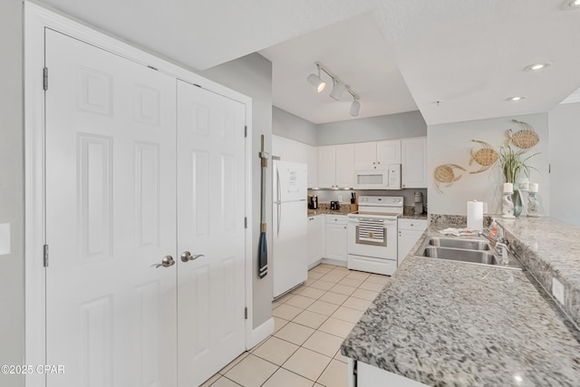 14701 Front Beach Rd Unit 834, Panama City Beach, FL 32413 - kitchen with white appliances, light tile patterned floors, a sink, white cabinetry, and rail lighting