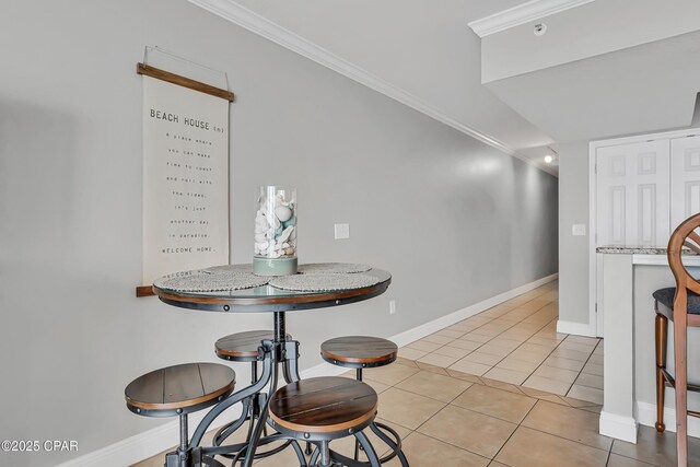 14701 Front Beach Rd Unit 834, Panama City Beach, FL 32413 - dining area featuring baseboards, light tile patterned floors, and ornamental molding