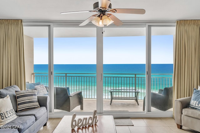 14701 Front Beach Rd Unit 834, Panama City Beach, FL 32413 - living room with tile patterned flooring, view of water and beach, ceiling fan, and floor to ceiling windows