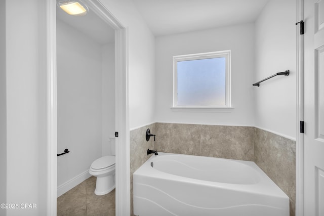 full bath featuring toilet, tile patterned flooring, and a bath