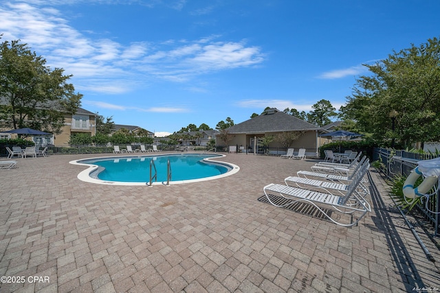 pool featuring a patio and fence