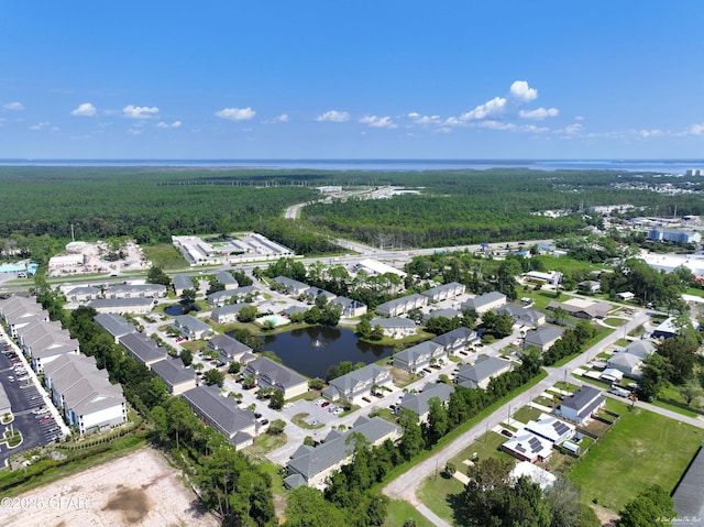 birds eye view of property featuring a residential view, a water view, and a forest view