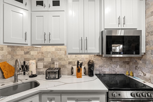 17462 Front Beach Rd Unit 24C, Panama City Beach, FL 32413 - kitchen featuring stainless steel appliances, a sink, and white cabinetry