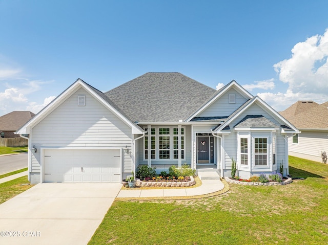 view of front of house with an attached garage, a shingled roof, driveway, and a front yard