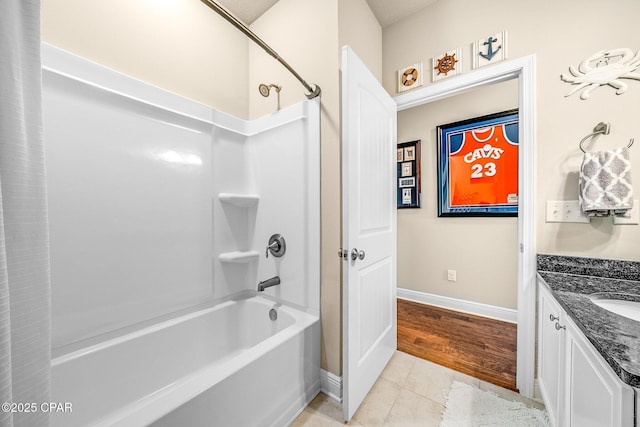 full bath featuring shower / bath combination, baseboards, tile patterned flooring, and vanity