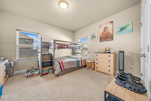bedroom with baseboards and carpet