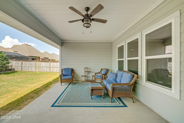 view of patio / terrace with fence and a ceiling fan
