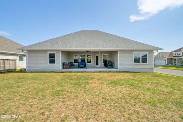 rear view of house featuring a ceiling fan, a patio area, fence, and a yard