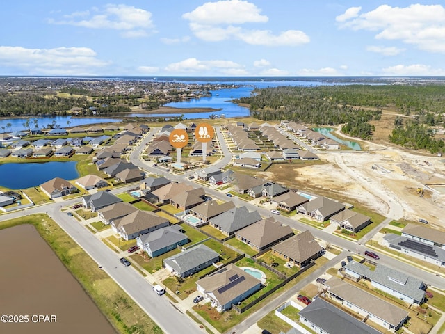 birds eye view of property with a water view and a residential view