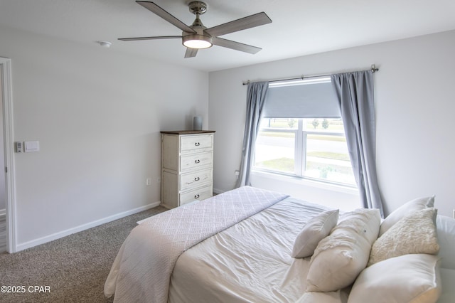 carpeted bedroom featuring baseboards and ceiling fan