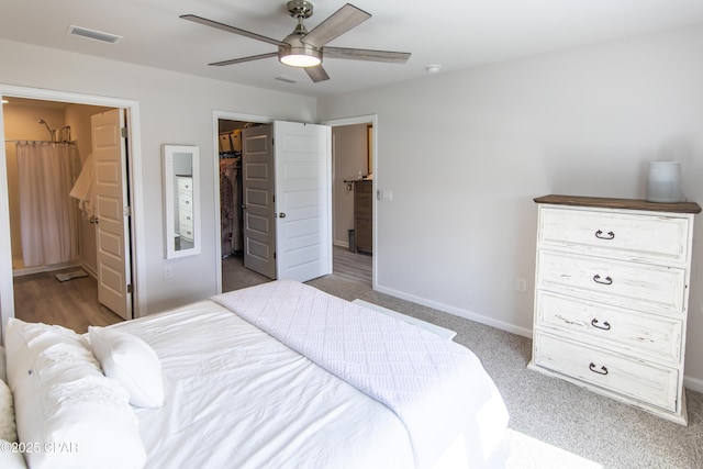 bedroom with visible vents, a closet, baseboards, a spacious closet, and a ceiling fan