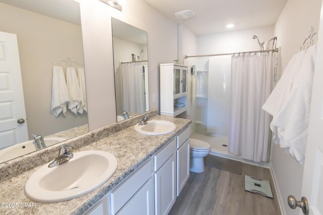 4963 Shurer Ln, Panama City, FL 32404 - bathroom featuring a sink, a shower with curtain, toilet, and wood finished floors