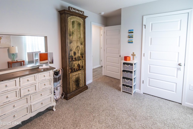 bedroom featuring baseboards and carpet