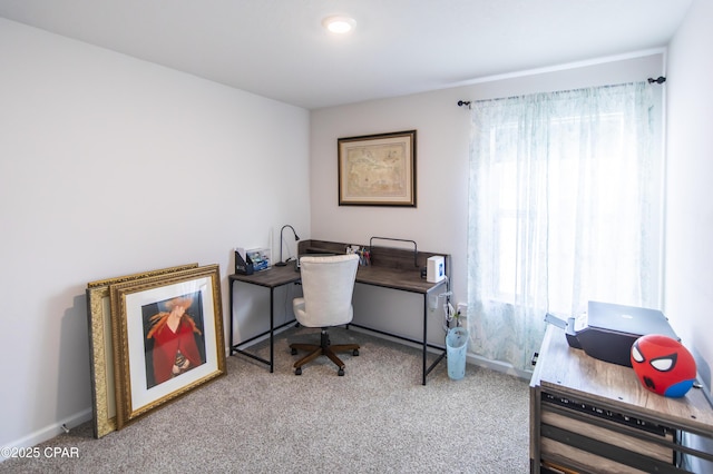 office space featuring carpet floors, plenty of natural light, and baseboards