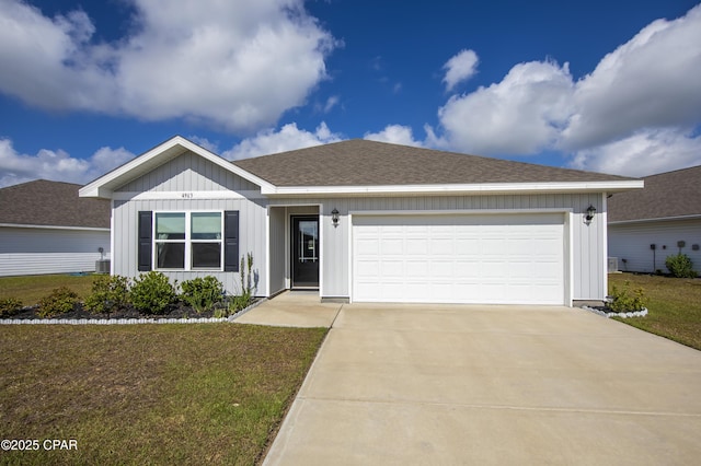 ranch-style home with an attached garage, board and batten siding, a front yard, cooling unit, and driveway