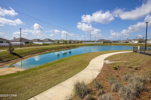 surrounding community with a lawn, a water view, and a residential view