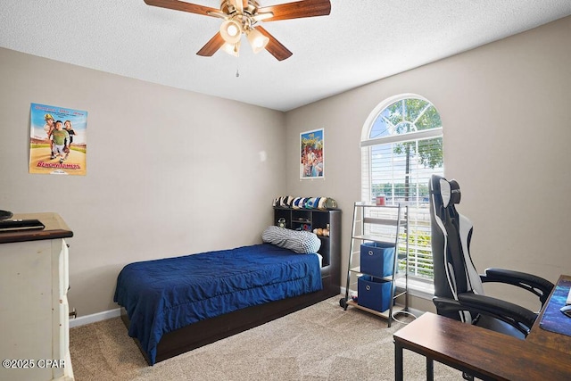 bedroom featuring a textured ceiling, baseboards, ceiling fan, and carpet floors
