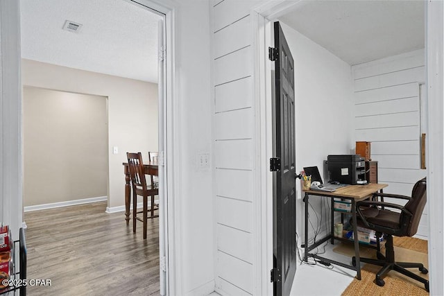 office area featuring visible vents, wood finished floors, and baseboards