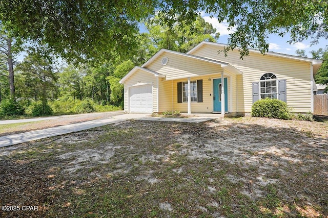 bungalow-style house with a porch, driveway, and a garage
