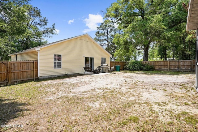 rear view of property featuring a fenced backyard