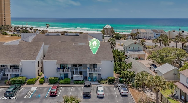drone / aerial view featuring a water view and a beach view