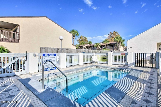 view of swimming pool featuring fence and a swimming pool