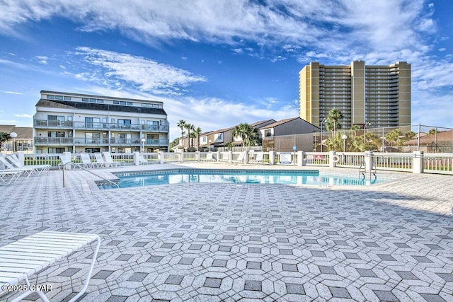 pool with fence and a patio area
